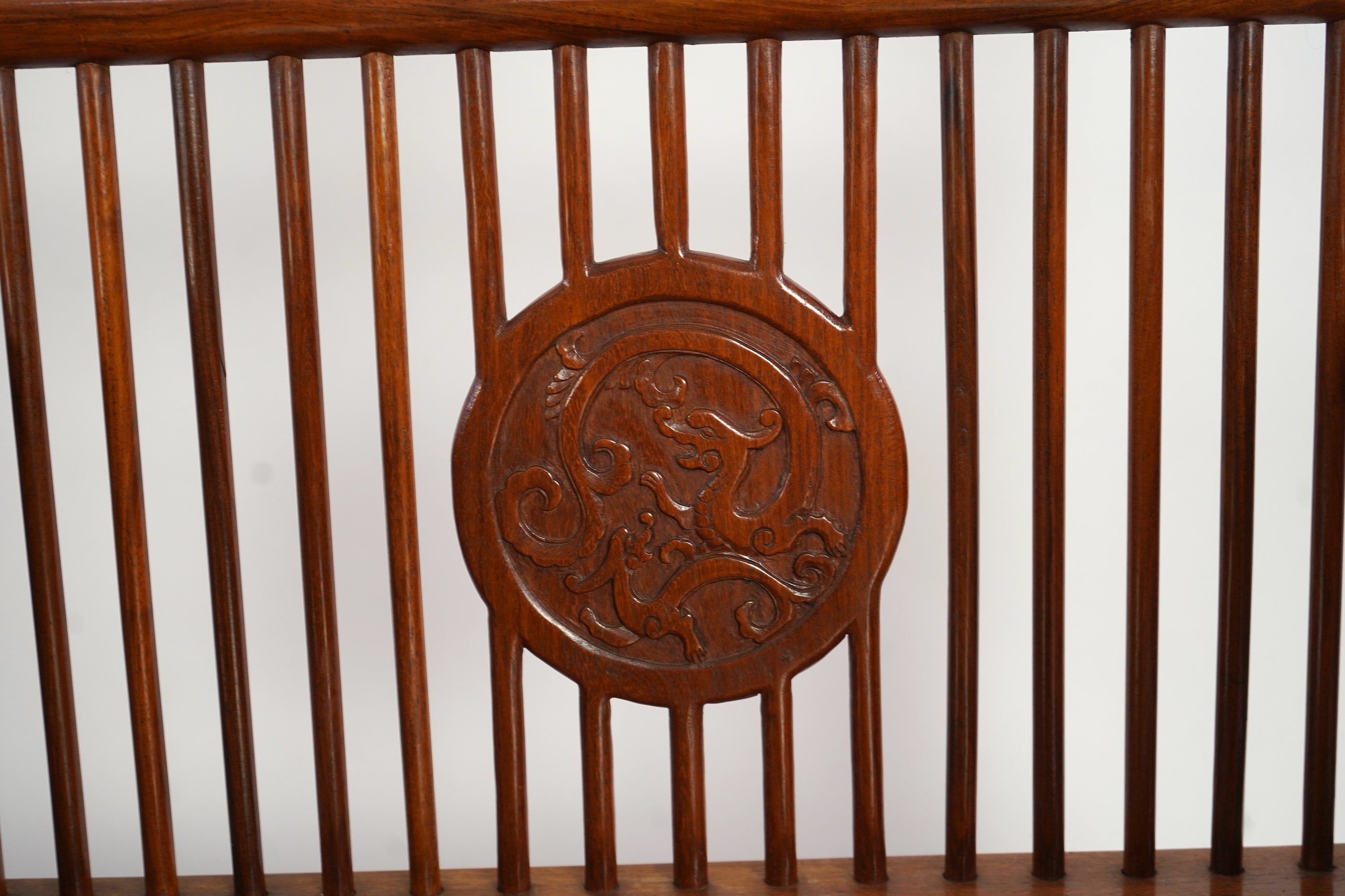 A Chinese hardwood and burrwood inset spindle-back bench, early 20th century